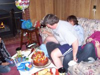 100 1006  Ann Marie getting between Joe and his numerous cakes.